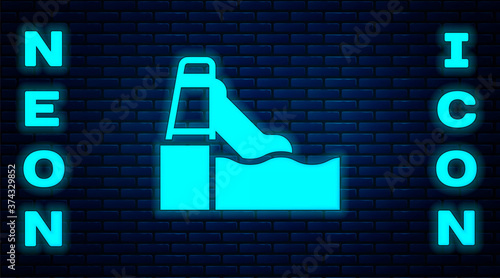 Glowing neon Water slide with pool icon isolated on brick wall background. Aquapark. Vector.