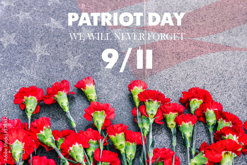 Carnations on the memorial with the American flag and the phrase patriots ' Day. September 11. We will never forget. Anniversary of the attack.