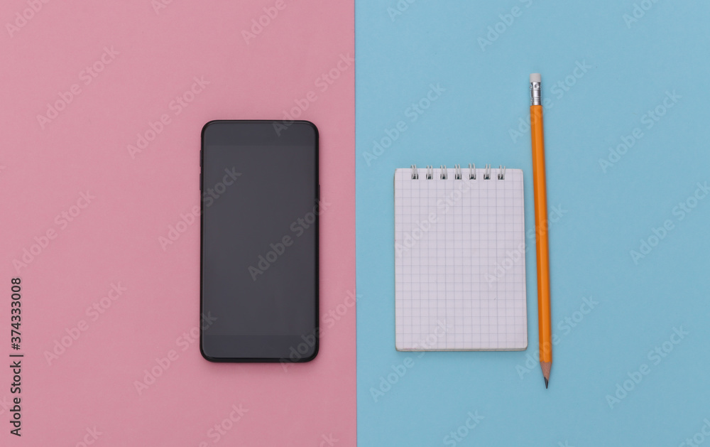 Notebook with pencil, smartphone on pink blue background. Top view Notebook with pencil, smartphone on pink blue background. Top view
