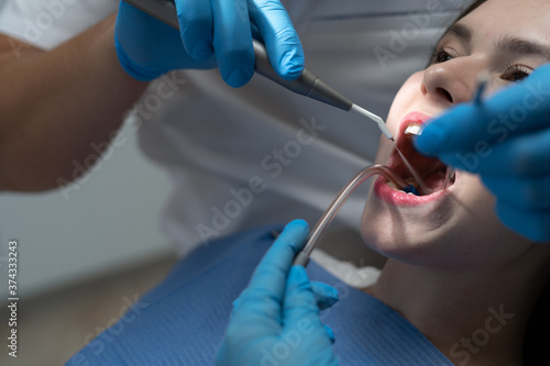 Dentist treating female patient. Healthy teeth