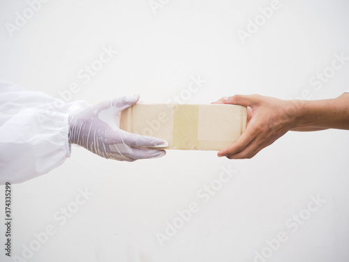 Coronavirus or COVID-19 concept. Protected contact between courier and client during quarantine on white background