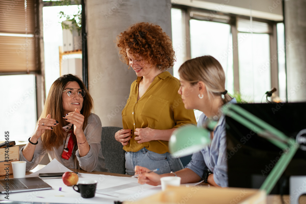 Businesswomen working on a new project. Colleagues discussing about problem they have to solved.. Businesswomen working on a new project. Colleagues discussing about problem they have to solved..