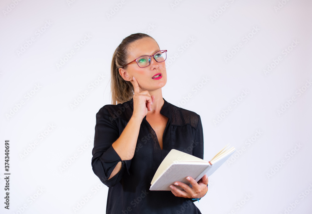 Pretty businesswoman with a notebook with doubtful gesture Pretty businesswoman with a notebook with doubtful gesture