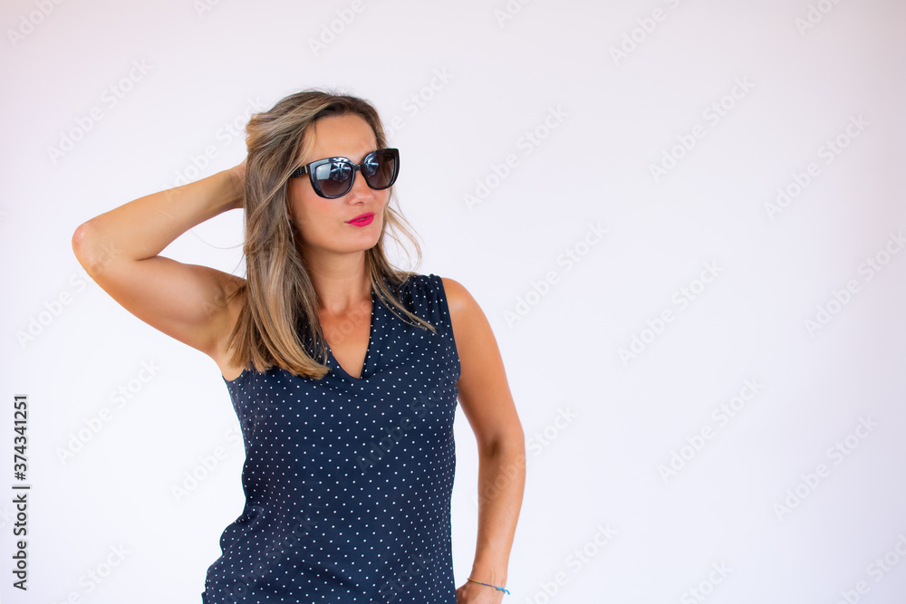 Beautiful woman in blue shirt and sunglasses posing Beautiful woman in blue shirt and sunglasses posing