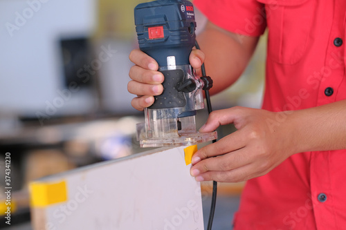Young carpenter using a laminate trimmer