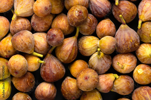 Fresh ripe figs as background, top view. Tropical fruit.