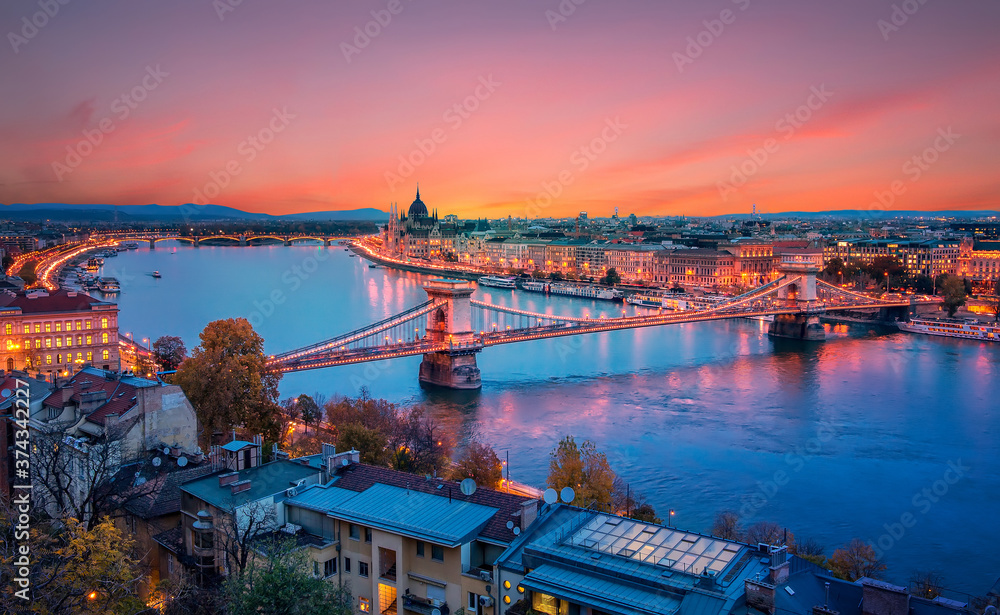 Fantastic picturesque cityscape of Budapest during sunset. panoramic view of Budapest city, Hungarian parliament building and Szechenyi Chain Bridge with stritlight along Danube river, Hungary.