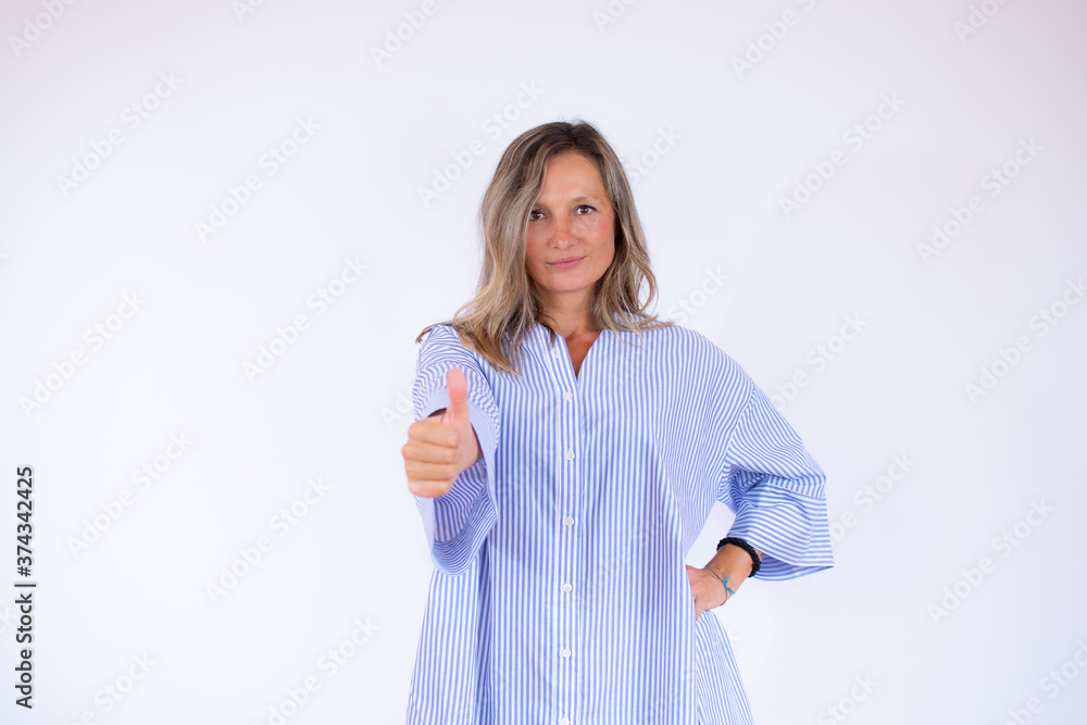 Pretty woman in striped blouse with thumb up Pretty woman in striped blouse with thumb up