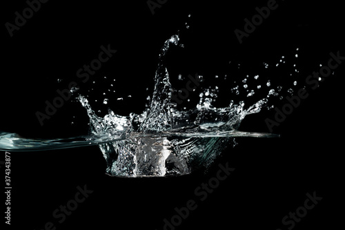 close up of water waves splash and bubbles isolated on black background.