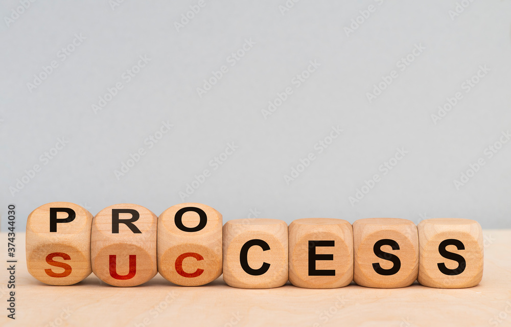 process and success printed on wooden cubes process and success printed on wooden cubes