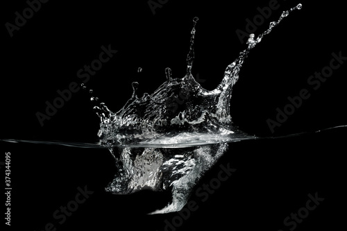 close up of water waves splash and bubbles isolated on black background. © Suprachai