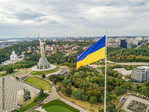 Aerial drone view. Ukrainian flag on a high flagpole in Kiev.