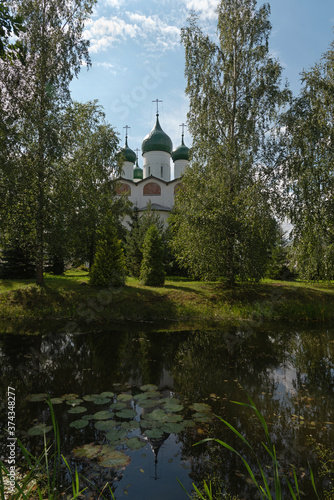 Vyazhishchsky monastery.Veliky Novgorod.Church and trees with reflection in the water of the pond.Summer view