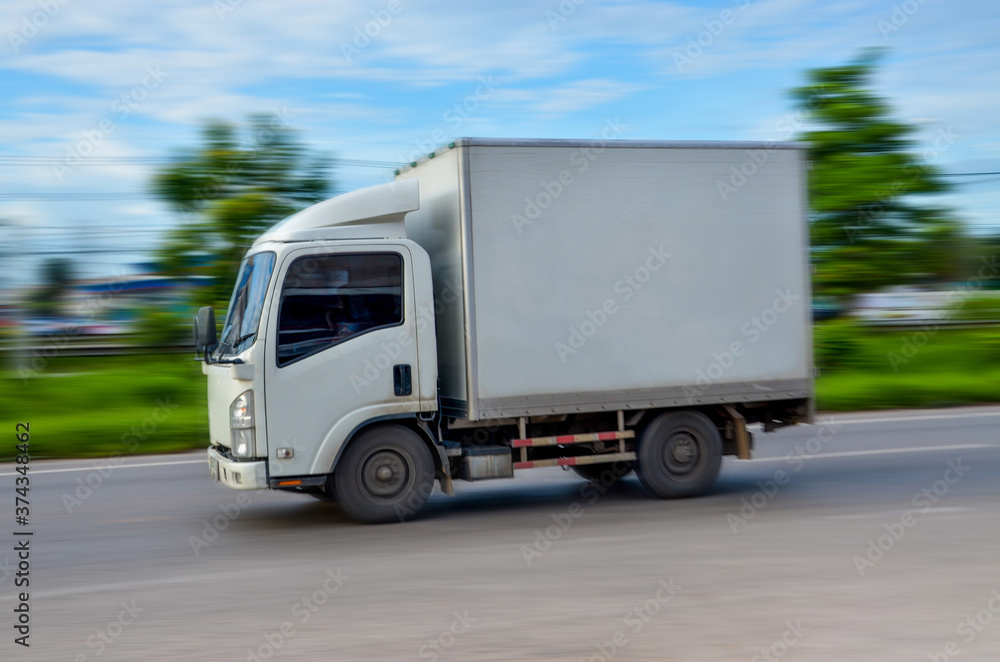 Motion image of the white truck driving on the road  with speed, Motion blur