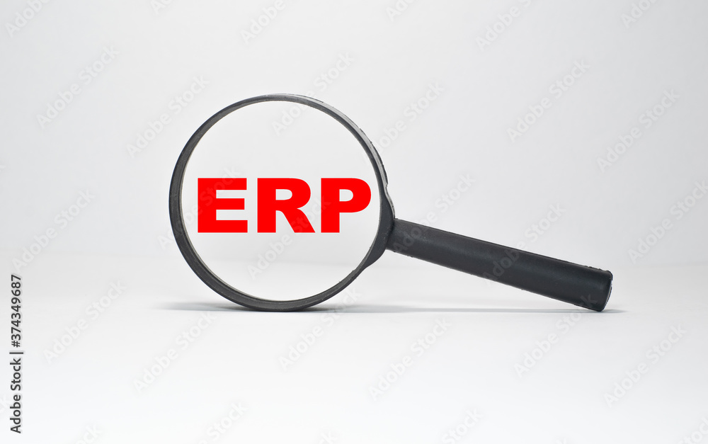 ERP the word on wooden cubes, cubes stand on a reflective surface, in the background is a business diagram. Business and finance concept ERP the word on wooden cubes, cubes stand on a reflective surface, in the background is a business diagram. Business and finance concept