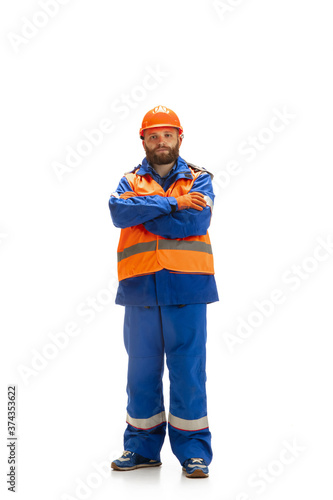 Handsome contractor, builder isolated over white studio background. Concept of professional occupation, work, job, building, investment. Copyspace for ad, text. Caucasian man wearing equipment. © master1305