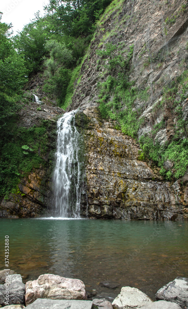 Fototapeta premium High mountain with a waterfall.Mountain landscape in summer