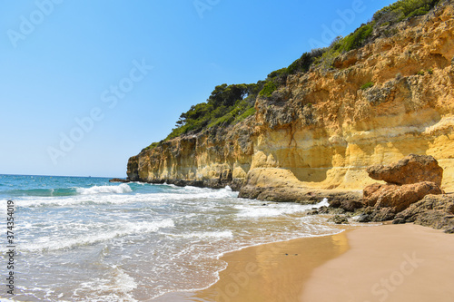 Beach on the golden coast of Tarragona, small waves and fine golden sand.