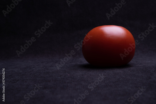 Beautiful natural tomatoes on a black background