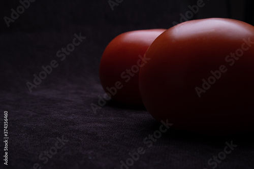Beautiful natural tomatoes on a black background © Иван Белых