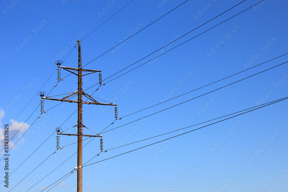 Power pole and power lines against the blue sky Power pole and power lines against the blue sky