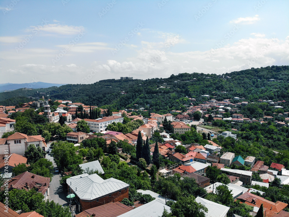 Obraz premium Aerial view on Mountains and City Roofs