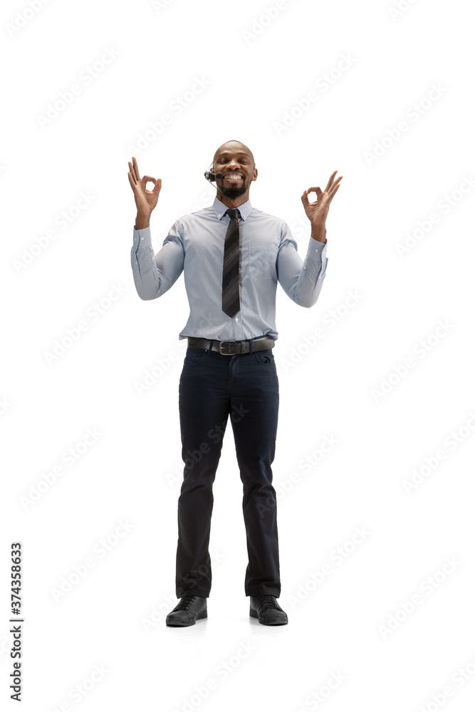 Calm and happy. Young african-american call center consultant with headset on white studio background. Copyspace for ad, text. Concept of professional occupation, work, job, communication. Calm and happy. Young african-american call center consultant with headset on white studio background. Copyspace for ad, text. Concept of professional occupation, work, job, communication.