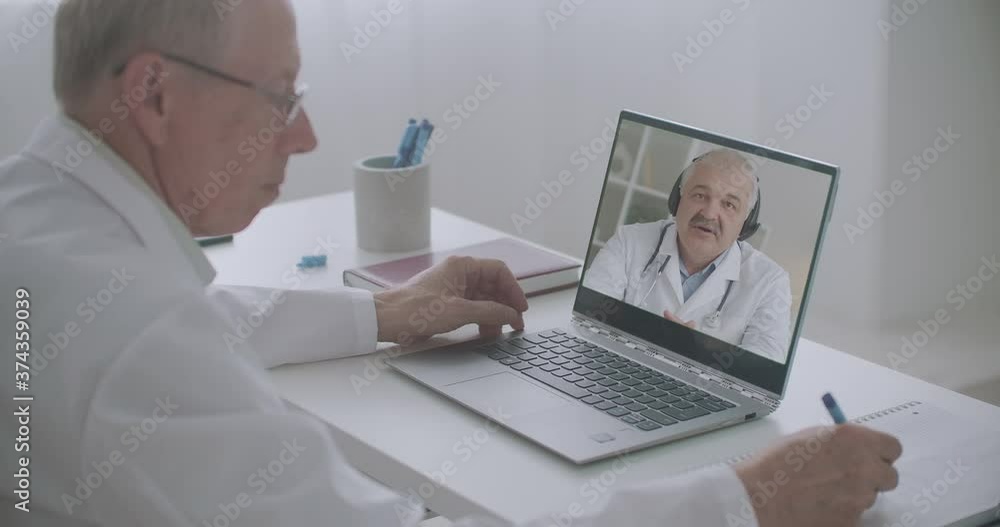 two virologists and infectiologist are discussing pandemic of coronavirus, chatting by web camera of notebooks two virologists and infectiologist are discussing pandemic of coronavirus, chatting by web camera of notebooks
