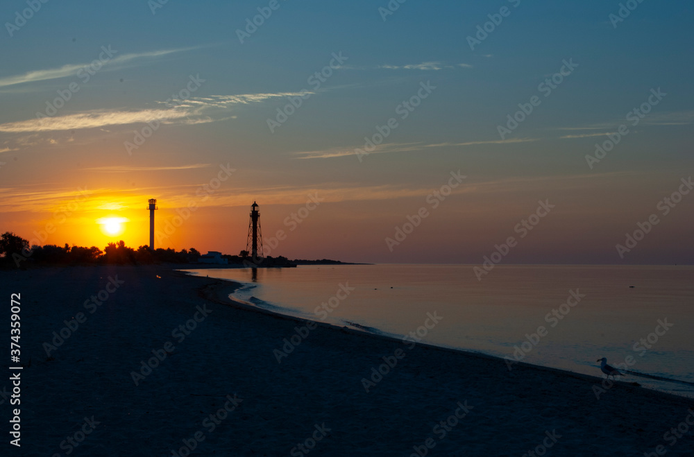 Beautiful sea sunrise with lighthouses. lighthouse on Dzharylgach island, Kherson region. Old lighthouse on the seaside in Ukraine. Beautiful sea sunrise with lighthouses on Dzharylgach island.