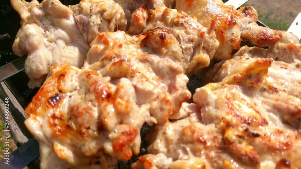 Close up shot of appetizing hot shish kebab on metal skewers prepares on the coals outdoors. Grilling shashlik. Close up shot of appetizing hot shish kebab on metal skewers prepares on the coals outdoors. Grilling shashlik.