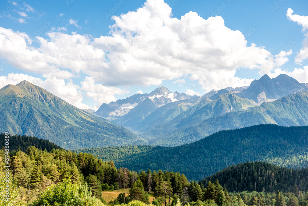 Fototapeta premium Caucasus mountains in the country of Russia. Beautiful mountain landscape. Nature and mountain background. Mountain landscape and large white clouds over the mountains.