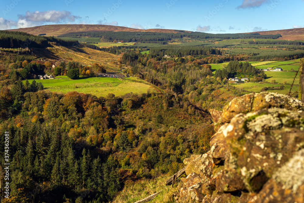 Autumn coloured trees in the valley of Glenariff Forest Park. View from the top of the surrounding cliffs, Count Antrim, Northern Ireland