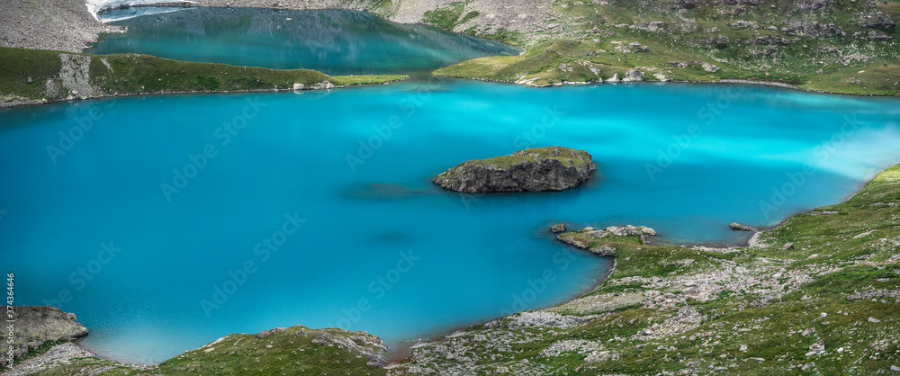 Panoramic view of blue lake water with island