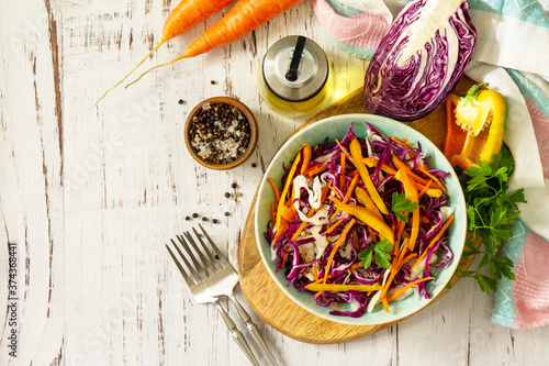 Cole Slaw. Cabbage salad in a bowl on a wooden table. Top view flat lay background. Copy space.