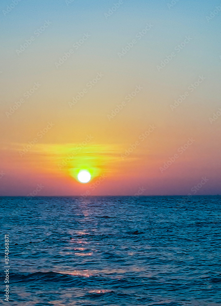 The sun shines brightly on a warm evening before sunset in the sea on Phuket Island.