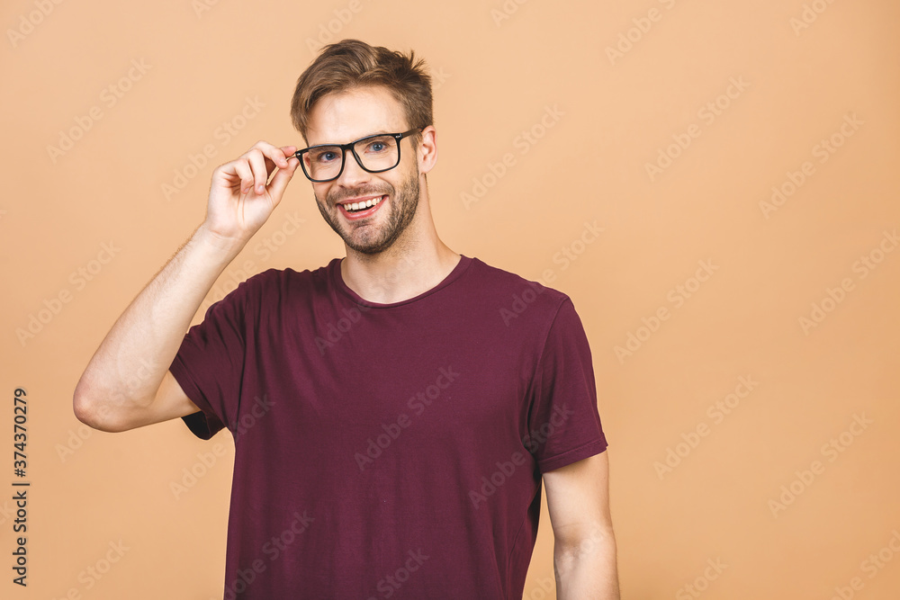 Portrait of a handsome man in glasses against beige background with copy space. Smiling guy in casual standing in casual isolated. Successful hispanic man looking at camera. Portrait of a handsome man in glasses against beige background with copy space. Smiling guy in casual standing in casual isolated. Successful hispanic man looking at camera.