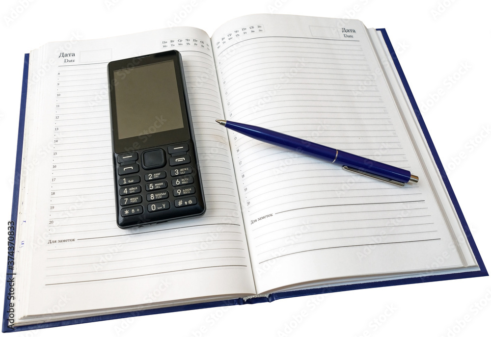 Notebook, pen and cellular telephone on a white Notebook, pen and cellular telephone on a white
