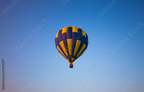 Big balloon flies against the sky