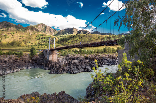 Fototapeta Naklejka Na Ścianę i Meble -  Mountain landscape with a bridge over the Katun river. Altai Republic