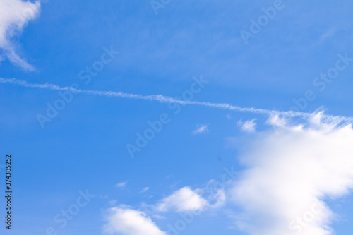 bright blue sky with vapor trail