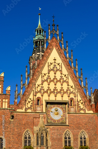 Sightseeing of Wroclaw, Poland. City hall of Wroclaw - the monument of architecture in the Gothic style. Detail of the facade with an astonomical clock. photo