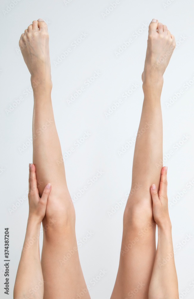 Perfect clean female feet . Beautiful and elegant groomed girl hand touches her feet . Spa ,scrub and foot care . Perfect clean female feet . Beautiful and elegant groomed girl hand touches her feet . Spa ,scrub and foot care .
