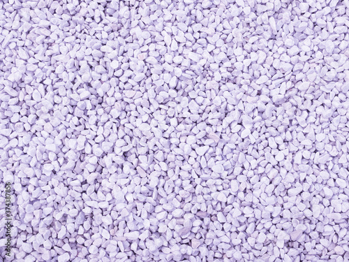 Texture background made of small stones toned purple. Used in gardening and landscape decoration.