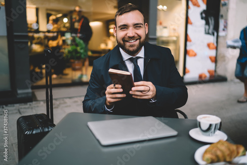 Happy businessman smiling in cafe