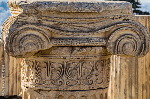 Close-up of the remains of the column with its Ionic capital with scrolls and flourishes on the Acropolis of Athens. Athens. Greece. photo