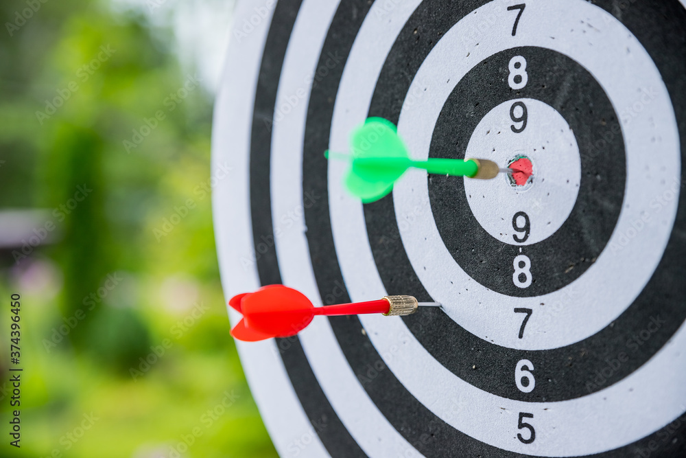 Dartboard with darts. side view of Dartboard with two darts.successful attempt. To attempt difficult task.Dart in bullseye of dartboard concept for hitting target dart, success concept Dartboard with darts. side view of Dartboard with two darts.successful attempt. To attempt difficult task.Dart in bullseye of dartboard concept for hitting target dart, success concept