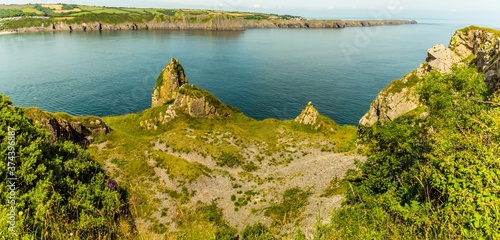 The Limestone cliffs of Gilter Point viewed from Lydstep Cavens, Wales in early summer photo