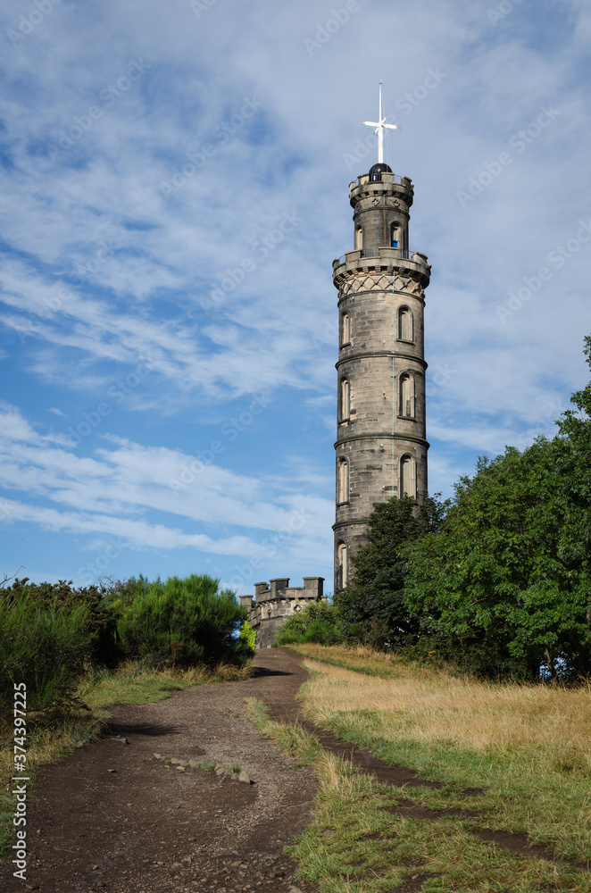 Nelson Monument on Calton Hill on a day with clouds and blue sky, Edinburgh, Scotland