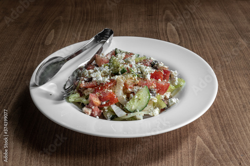 Fresh Greek Salad server in white plate,