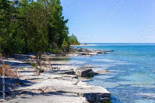 rocky coast and aquamarine water of Great Lakes - Huron Lake, Manitoulin Island, Canada photo
